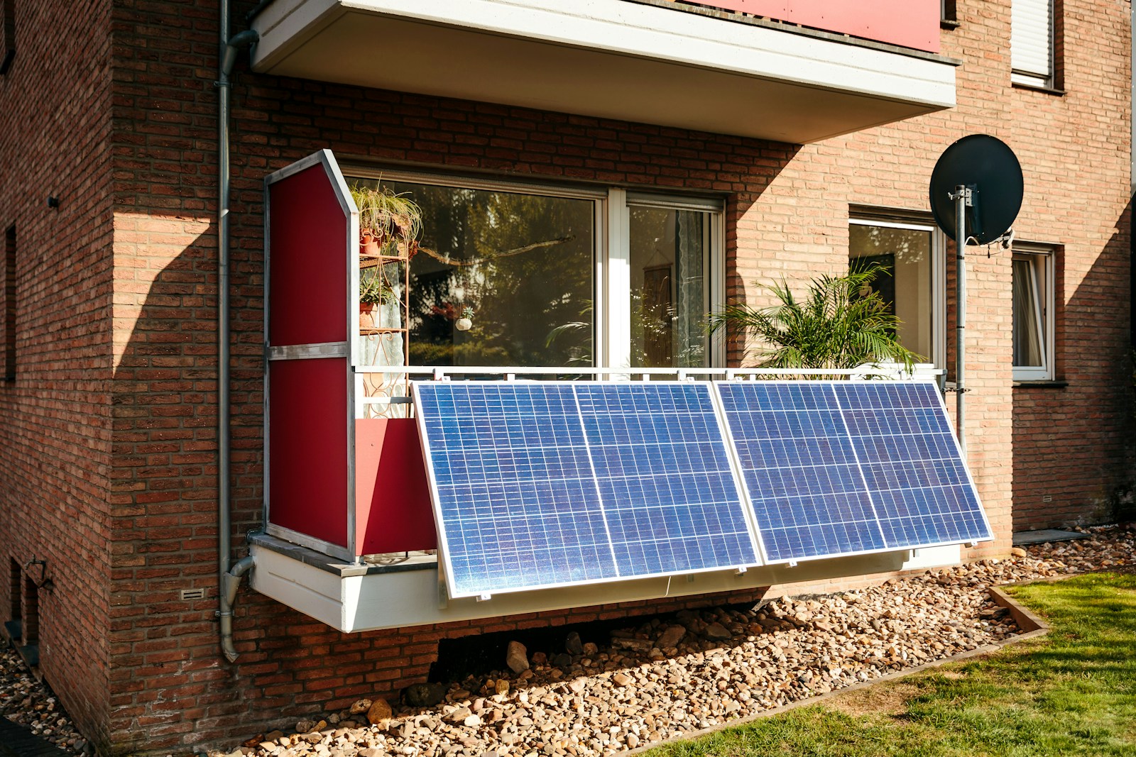 Solar panels on a brick building balcony.